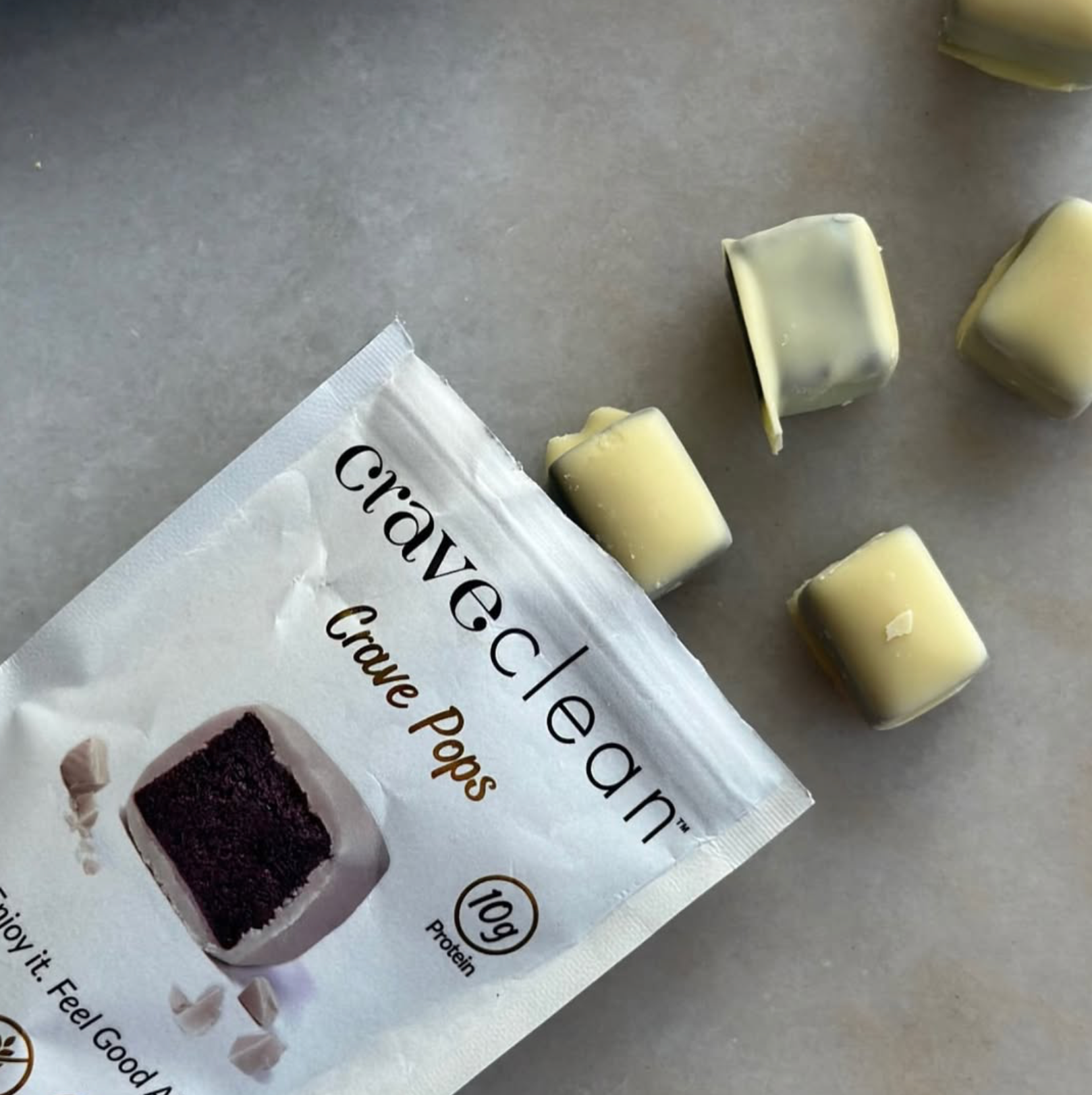 Craveclean Crave Pops packaging with white chocolate pieces on a gray surface