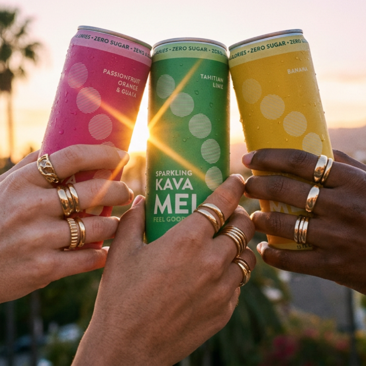 Three friends touching cans of Melo together at sunset