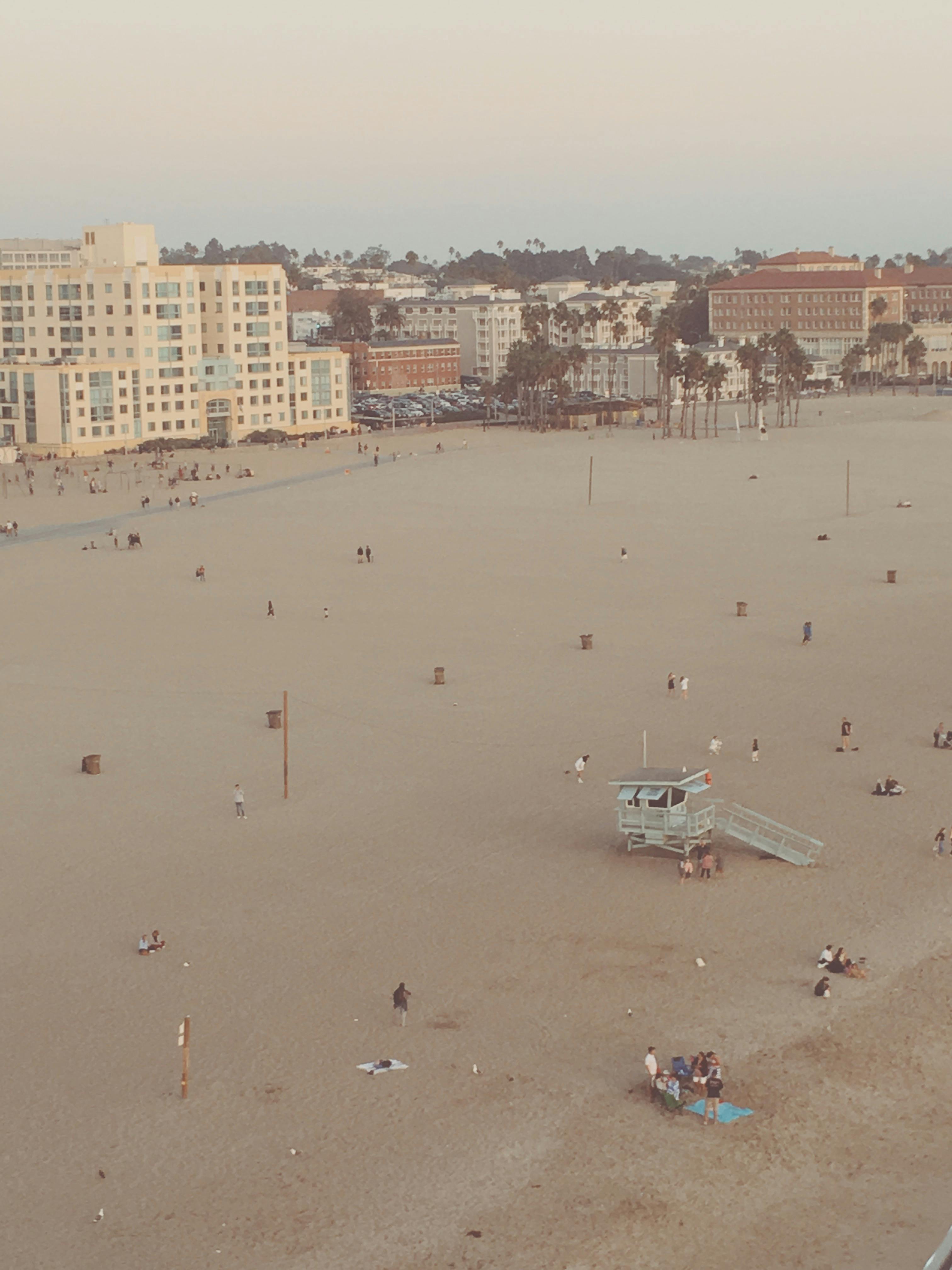 Beach scene with buildings and a lifeguard tower in the background