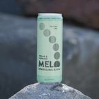 Melo sparkling kava can on a rock with a blurred natural background